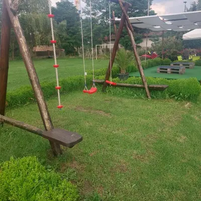 a swing yard with two swings in a yard at Комплекс Александьр между Банско и село Бяня in Bansko