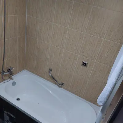 a bath tub with a faucet in a bathroom at Комплекс Александьр между Банско и село Бяня in Bansko