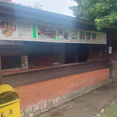 a fast food restaurant with plates of food on the window at Комплекс Александьр между Банско и село Бяня in Bansko
