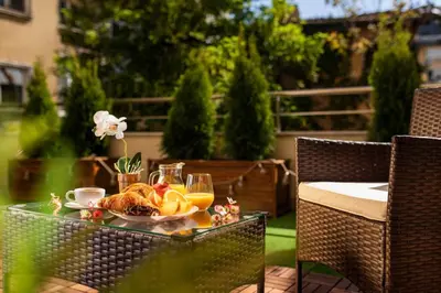 a table with a plate of food and orange juice at Free Parking On Premises Huge Terrace in Sofia