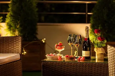 a table with wine glasses and a bottle of wine at Free Parking On Premises Huge Terrace in Sofia