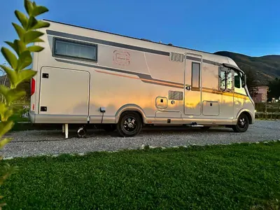 a silver caravan parked in a parking lot at 7 Lakes camping in Sapareva Banya