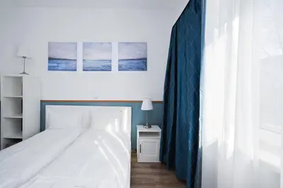 a bedroom with a white bed and a window at Charming Studio on Vitosha Street by Flat Mаnager in Sofia