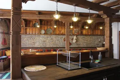 a kitchen with a counter top with a sink and a counter top at Кондеви къщи in Kovachevitsa