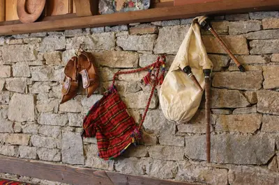 two bags hanging on a brick wall at Кондеви къщи in Kovachevitsa