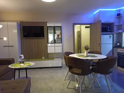 a kitchen and living room with a table and chairs at Azalia Sandanski in Sandanski