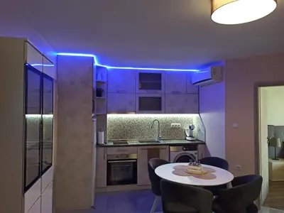 a kitchen with a table and a blue led lighting at Azalia Sandanski in Sandanski