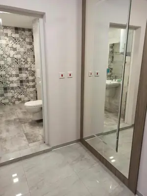 a bathroom with a toilet and a mirror at Azalia Sandanski in Sandanski