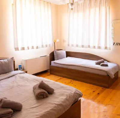 a bedroom with two beds and a window at Guesthouse Gaby in Sapareva Banya