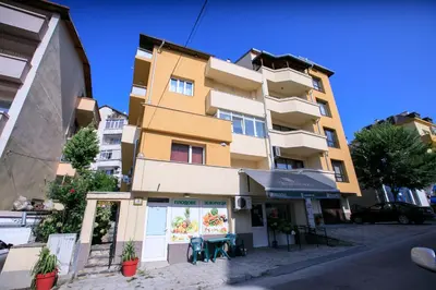a building with a restaurant in front of it at Мини Студио Рози in Sandanski
