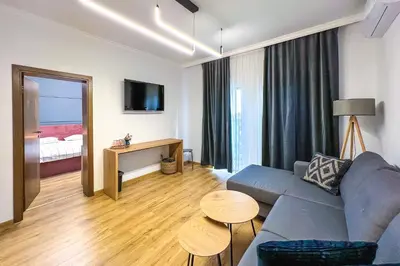 a living room with a couch and a table at Deluxe Central Rooms in Karlovo