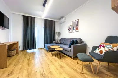 a living room with a couch and a table at Deluxe Central Rooms in Karlovo