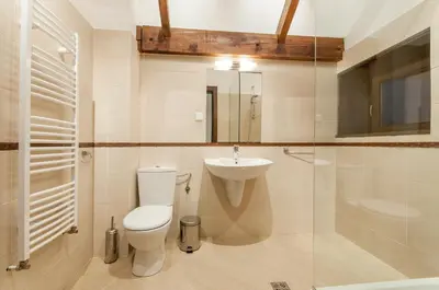 a bathroom with a toilet and a sink and a shower at Villa Chalet Everest in Bansko