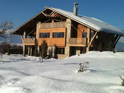 a log cabin in the snow with a snowboard at Villa Chalet Everest in Bansko
