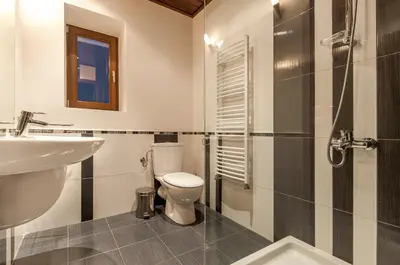 a bathroom with a toilet and a sink and a shower at Villa Chalet Everest in Bansko
