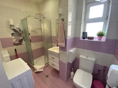 a bathroom with a shower and a toilet and a sink at Cozy apartment in downtown Sofia - Tsar Samuil Street in Sofia