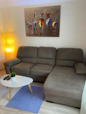 a living room with a couch and a table at Modern & Central 1BR Apartment with lovely terrace in Plovdiv