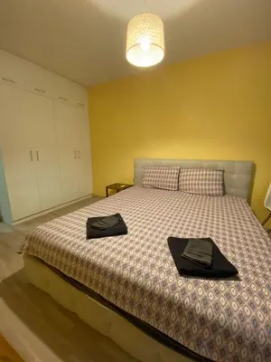 a bedroom with a bed with two black hats on it at Modern & Central 1BR Apartment with lovely terrace in Plovdiv