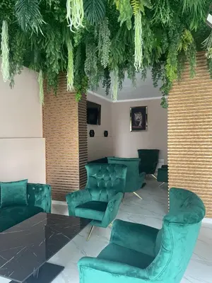 a room with green chairs and a table at Complex Nero in Pamporovo