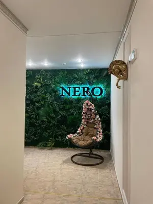 a chair in a room with a nore sign on the wall at Complex Nero in Pamporovo