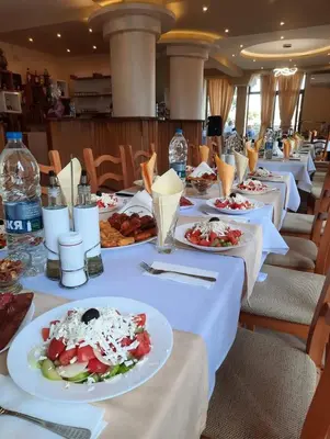 a row of tables with plates of food on them at Хотел-ресторант Русаков in Sandanski