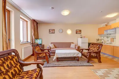 a living room with a couch and a table and chairs at Castle Romance - Pamporovo in Pamporovo