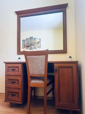 a wooden desk with a chair and a mirror at Castle Romance - Pamporovo in Pamporovo
