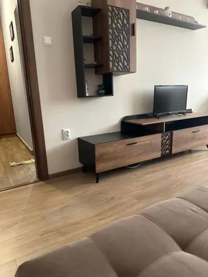 a living room with a couch and a tv at Rose in Karlovo