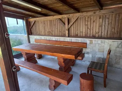 a wooden table and a chair in a cabin at Bansko All Seasons - Cozy Apartments Near Gondola & Mountain Views in Bansko