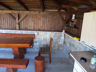 a kitchen with a table and a chair in a cabin at Bansko All Seasons - Cozy Apartments Near Gondola & Mountain Views in Bansko