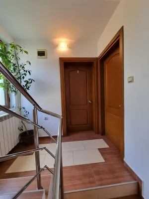 a hallway with a staircase leading to a door at Kaloyanova House Bansko in Bansko