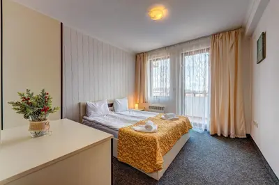 a bedroom with a bed and a large window at Colorful 2BD Apartment with Indoor Fireplace and Mountain View by Flat Mаnager in Pamporovo