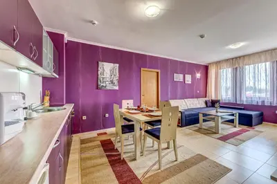 a kitchen and dining room with a purple wall at Colorful 2BD Apartment with Indoor Fireplace and Mountain View by Flat Mаnager in Pamporovo