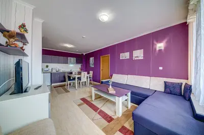 a living room with purple walls and a couch at Colorful 2BD Apartment with Indoor Fireplace and Mountain View by Flat Mаnager in Pamporovo