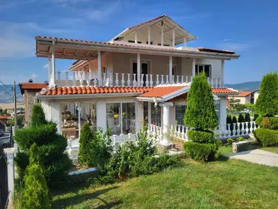 a white house with a white fence and trees at Белият кът in Sapareva Banya