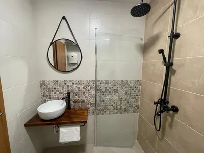 a bathroom with a sink and a mirror at Апартамент Стил in Chepelare