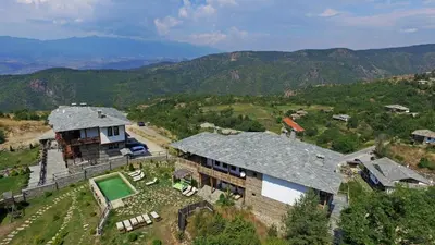 an aerial view of a house on a mountain at Панорама хаус Лещен и еко къщи Дървена и Землянка in Leshten