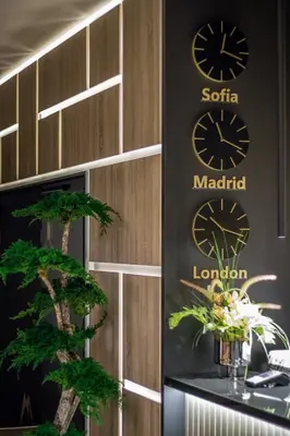 a building with two clocks on the side of it at EMAR HOTEL & SPA in Sapareva Banya