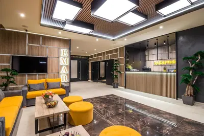 a lobby with a yellow couch and a table at EMAR HOTEL & SPA in Sapareva Banya
