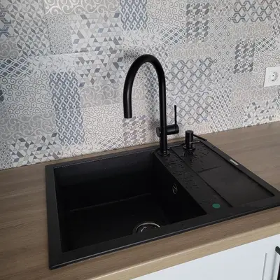a black sink in a kitchen with a wall at New luxury apartment next to subway with garage in Sofia