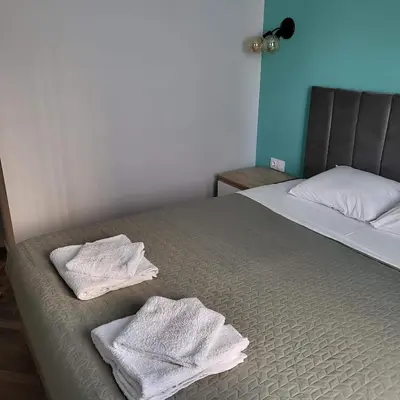 a bedroom with two towels on a bed at New luxury apartment next to subway with garage in Sofia