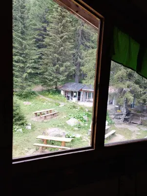 a view of a picnic table from a window at Хижа Ловна в Рила in Panichishte
