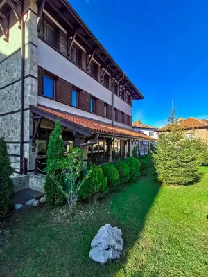 an exterior view of a building with a yard at Trinity Residence Bansko with Free Shuttle to Gondola in Bansko