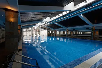 a large swimming pool in a building at Trinity Residence Bansko with Free Shuttle to Gondola in Bansko