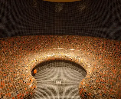 a tiled toilet in a bathroom with a tile floor at Trinity Residence Bansko with Free Shuttle to Gondola in Bansko
