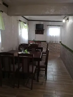 a dining room with tables and chairs and a television at Angel&MAR in Velingrad