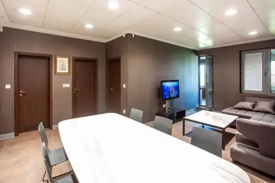 a bedroom with a bed and a living room with a couch at Apartment House - Delta in Sofia