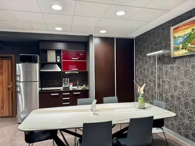 a kitchen and dining room with a table and chairs at Apartment House - Delta in Sofia