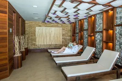 a man and woman sitting in chairs in a waiting room at Uva Nestum Wine & SPA in Gotse Delchev