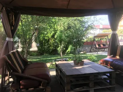 a screened in porch with a table and a couch at Къща ИВОНА in Sapareva Banya